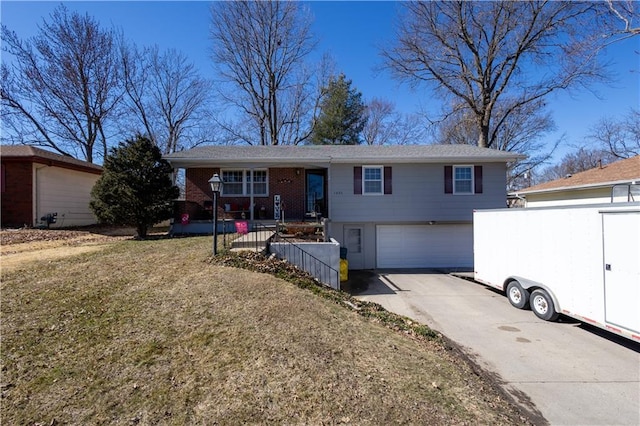 single story home featuring driveway, a front yard, and an attached garage