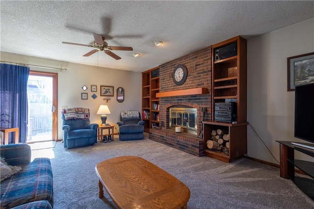 carpeted living room featuring built in features, a fireplace, a textured ceiling, and a ceiling fan