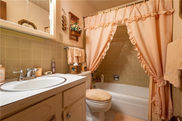 full bath with toilet, vanity, tile walls, and shower / bath combo with shower curtain