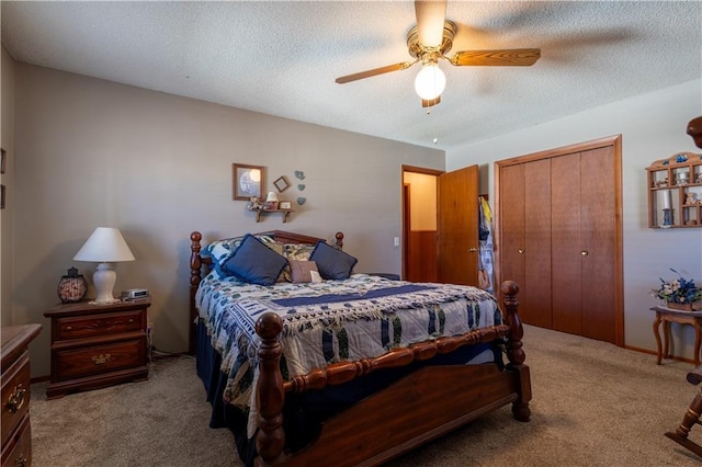 bedroom with a closet, ceiling fan, a textured ceiling, and carpet