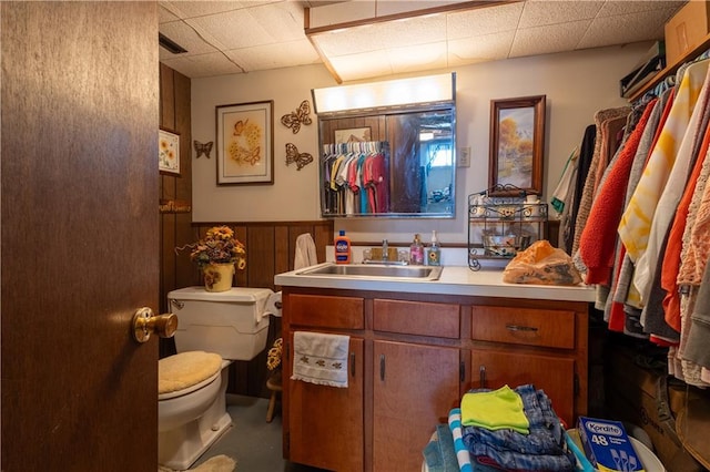 bathroom featuring visible vents, toilet, wainscoting, a paneled ceiling, and vanity