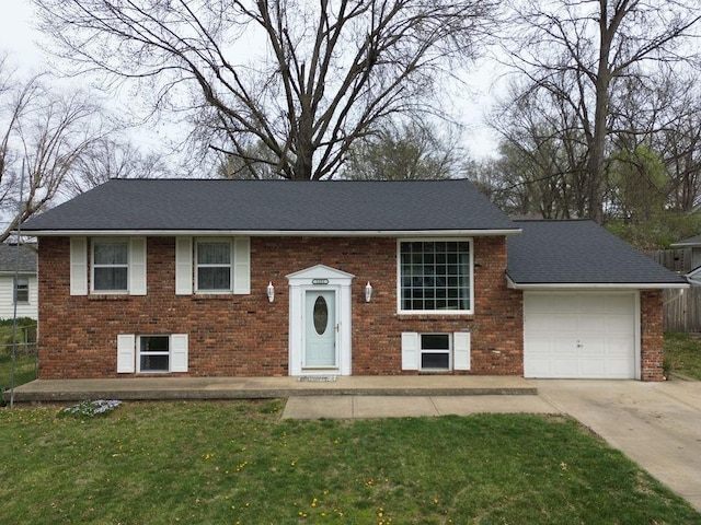 split foyer home featuring brick siding, an attached garage, and concrete driveway