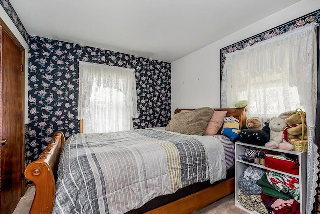 bedroom with carpet flooring and wallpapered walls