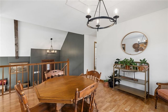 dining space featuring a notable chandelier and wood finished floors