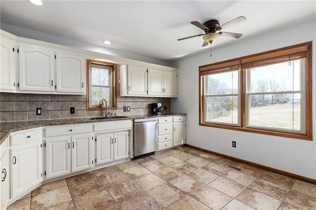 kitchen with a sink, backsplash, baseboards, and stainless steel dishwasher