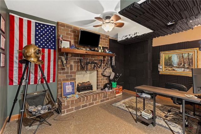 home office with a fireplace, speckled floor, and a ceiling fan