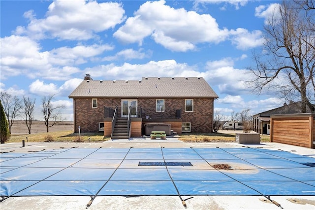 view of pool featuring a patio area, a covered pool, stairs, and a hot tub