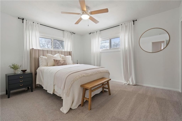 bedroom featuring baseboards, a ceiling fan, and light colored carpet