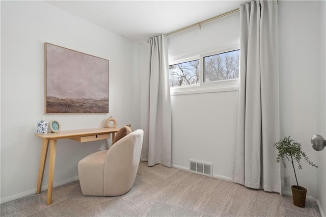 carpeted office space featuring visible vents and baseboards