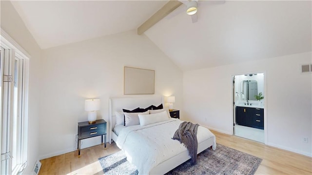 bedroom with visible vents, lofted ceiling with beams, light wood finished floors, and ensuite bathroom