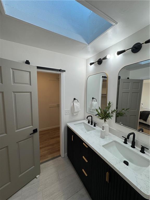 full bath with a sink and double vanity