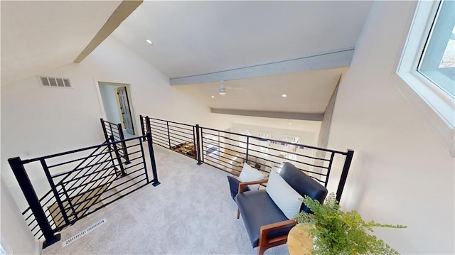 hallway featuring visible vents, an upstairs landing, carpet floors, high vaulted ceiling, and beam ceiling