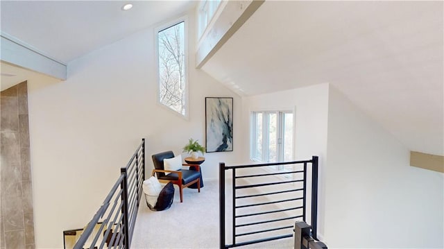 stairs featuring carpet floors and vaulted ceiling