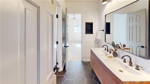 bathroom featuring double vanity, a sink, and tile patterned floors