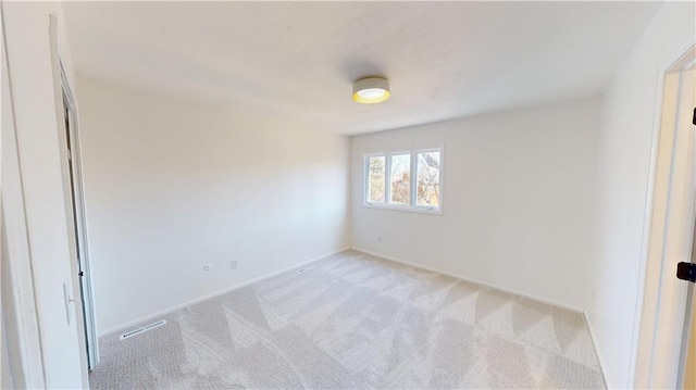 empty room with light colored carpet and visible vents