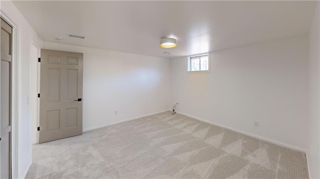 interior space featuring baseboards, visible vents, and light colored carpet