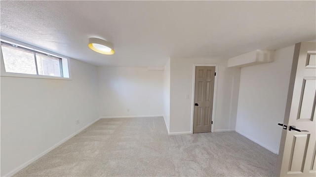 empty room with baseboards and light colored carpet