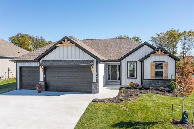 view of front facade featuring a garage, a shingled roof, driveway, stone siding, and board and batten siding