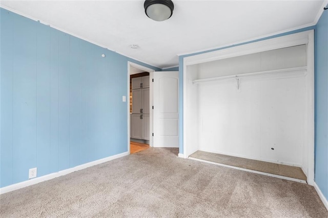 unfurnished bedroom featuring a closet and carpet flooring