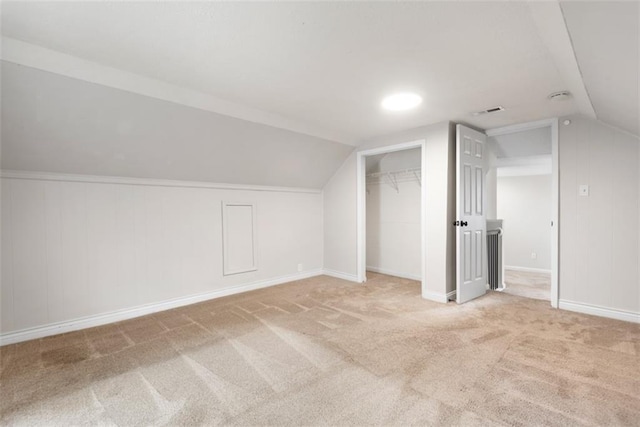 additional living space with lofted ceiling, carpet, and baseboards