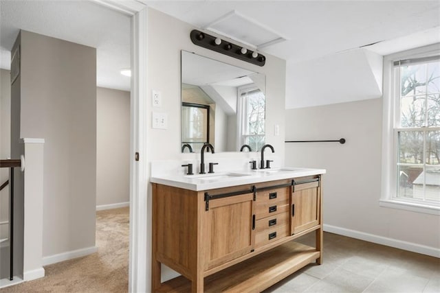 full bath featuring double vanity, a wealth of natural light, and a sink