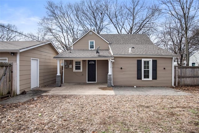 back of property featuring a patio area, fence, and roof with shingles