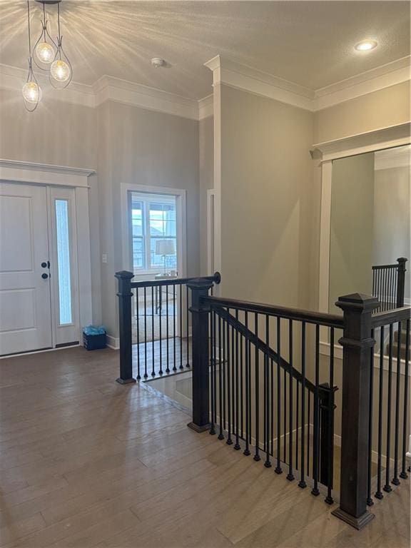 entryway featuring crown molding, baseboards, and wood finished floors