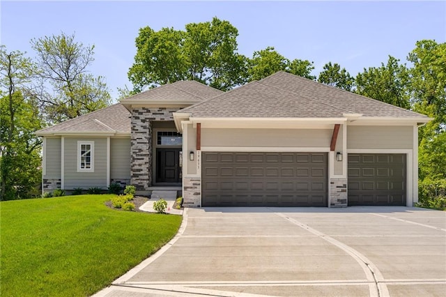 view of front of property with an attached garage, a shingled roof, concrete driveway, stone siding, and a front yard