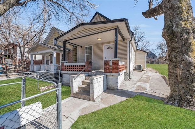 shotgun-style home with a front yard, covered porch, fence, and central air condition unit