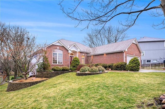 ranch-style home with a garage, brick siding, fence, roof with shingles, and a front yard