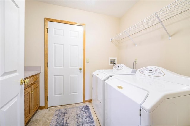 laundry room with cabinet space and washer and clothes dryer