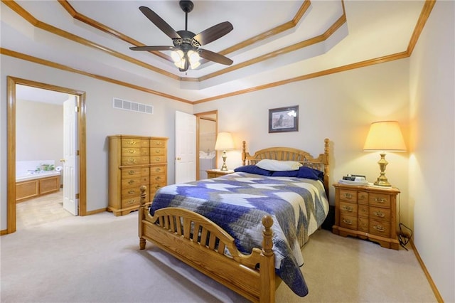 bedroom with a tray ceiling, visible vents, light colored carpet, ornamental molding, and baseboards