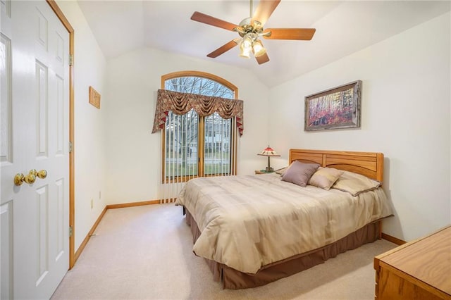 bedroom with carpet floors, baseboards, and vaulted ceiling