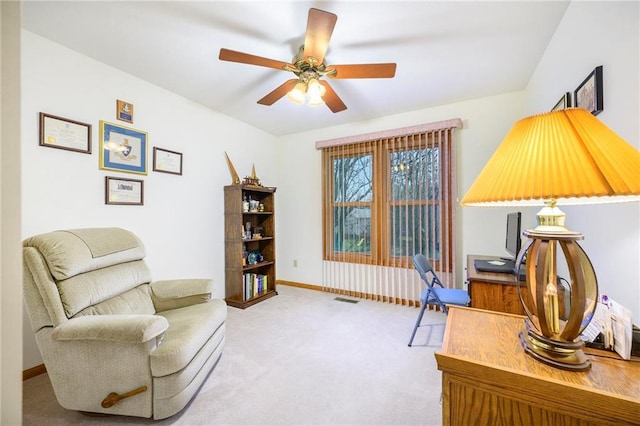 office area featuring baseboards, ceiling fan, visible vents, and carpet flooring