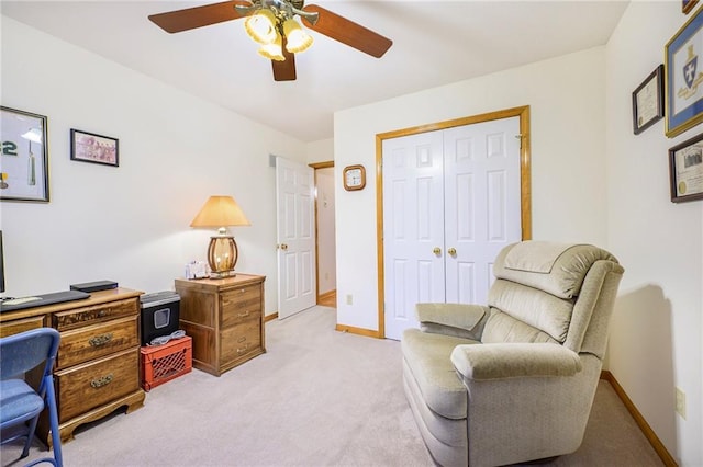 office area with light carpet, baseboards, and a ceiling fan