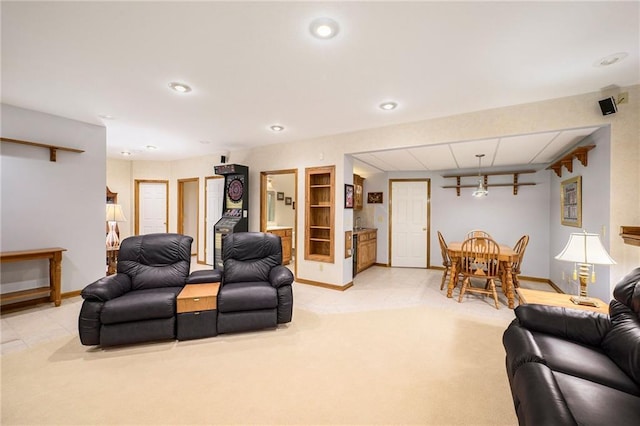 living area featuring light carpet, baseboards, and recessed lighting