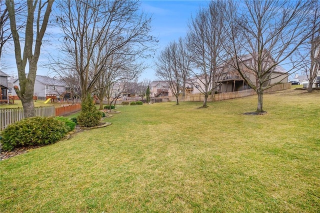 view of yard featuring fence and a residential view