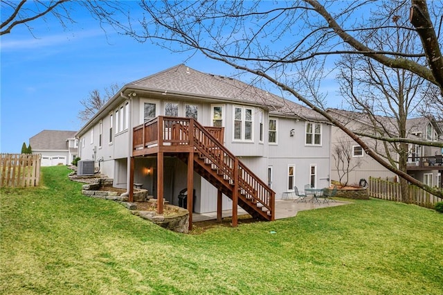 rear view of house with stairs, a yard, fence, and central air condition unit