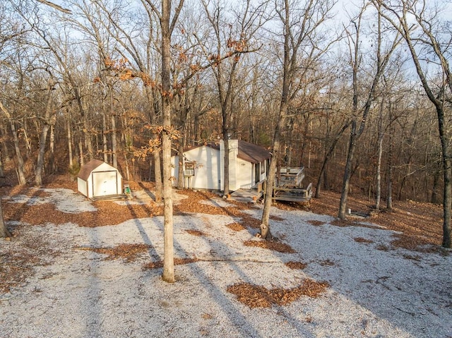 view of front of property with an outdoor structure and a shed