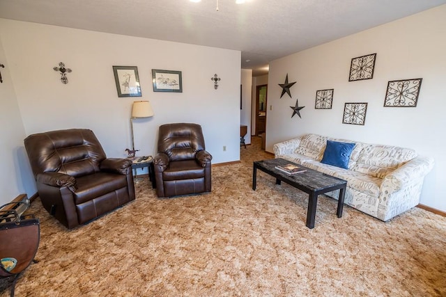 living area featuring carpet and baseboards