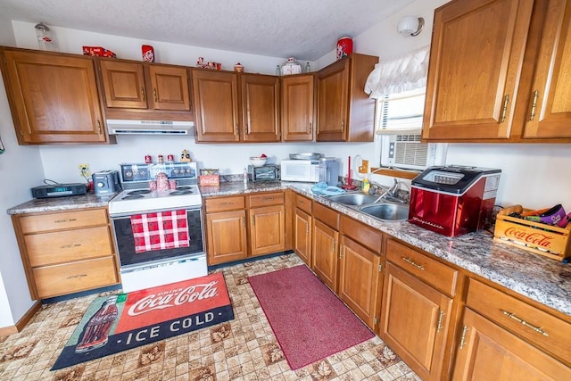 kitchen with brown cabinets, white appliances, a sink, and under cabinet range hood