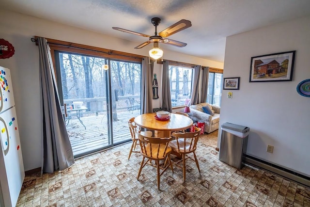 dining space featuring baseboards and a ceiling fan