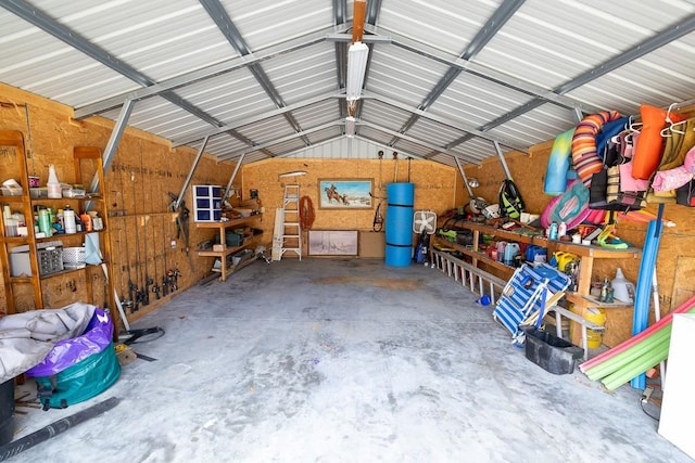 garage with a workshop area and metal wall