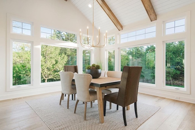 sunroom with vaulted ceiling with beams, visible vents, a chandelier, and a wealth of natural light