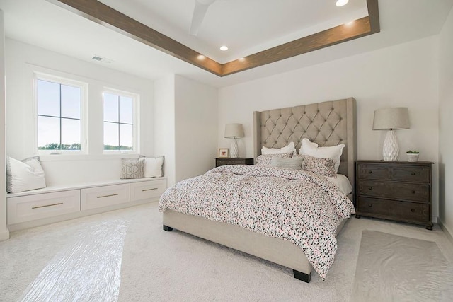 bedroom featuring recessed lighting, visible vents, a raised ceiling, and light colored carpet