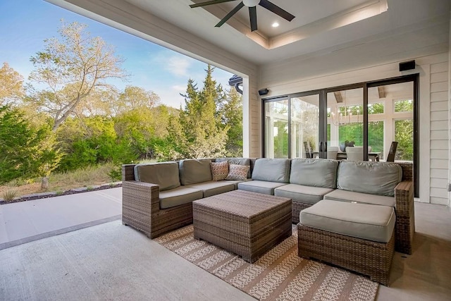 sunroom / solarium with a raised ceiling and ceiling fan