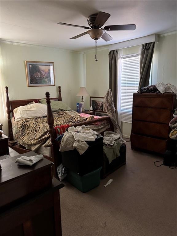 carpeted bedroom featuring ceiling fan and crown molding