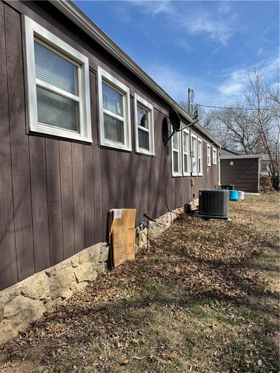 view of side of property featuring central AC