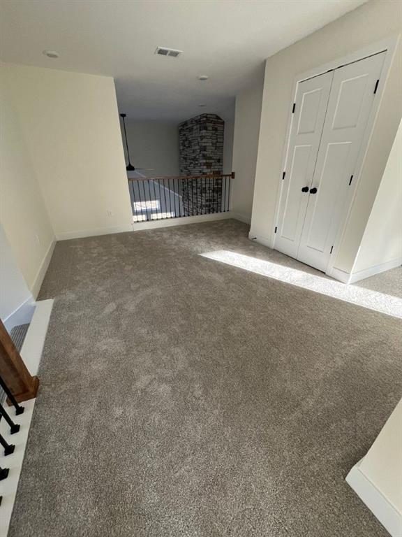 interior space with carpet, visible vents, and baseboards