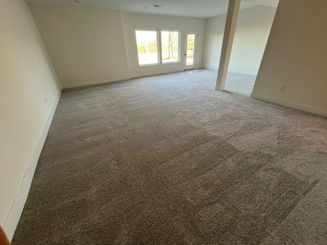 carpeted spare room with baseboards